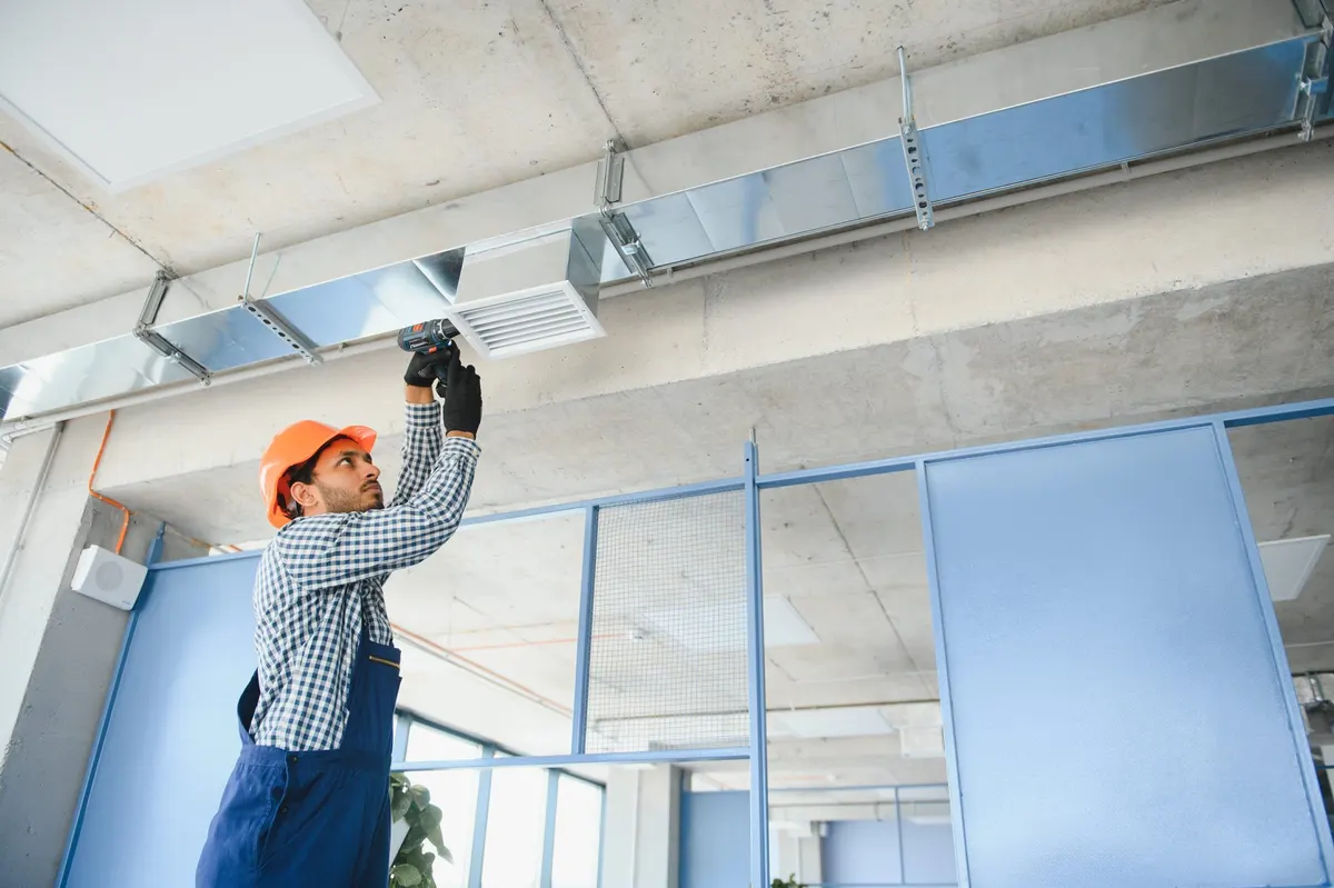 Commercial HVAC technician working on equipment